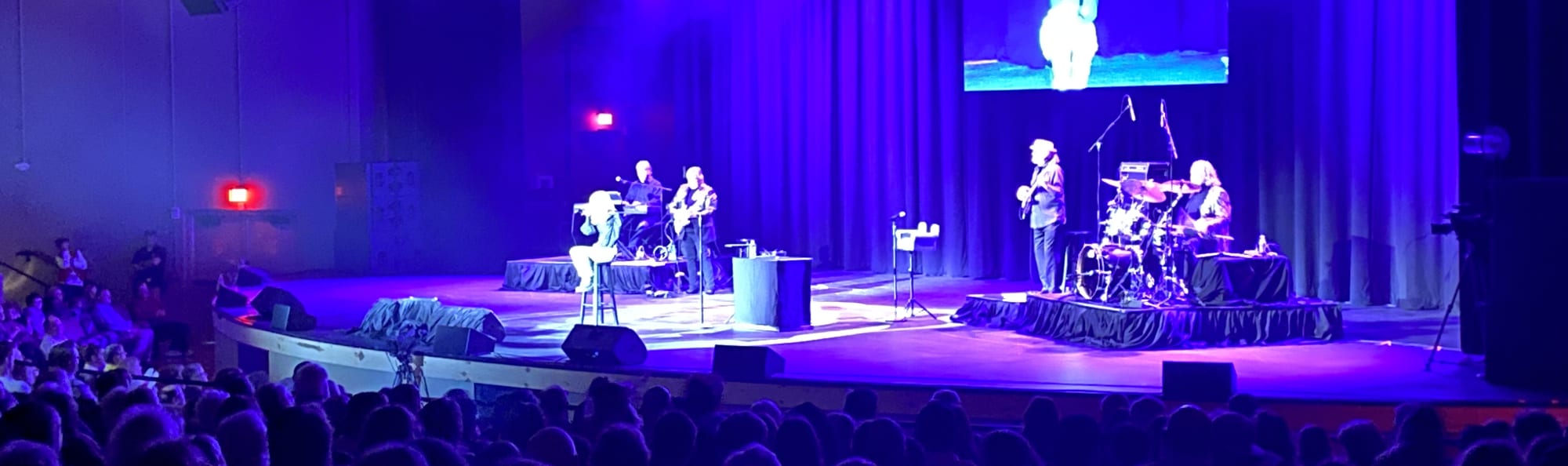 signer on stage in chair washed out by the lights Lubbock